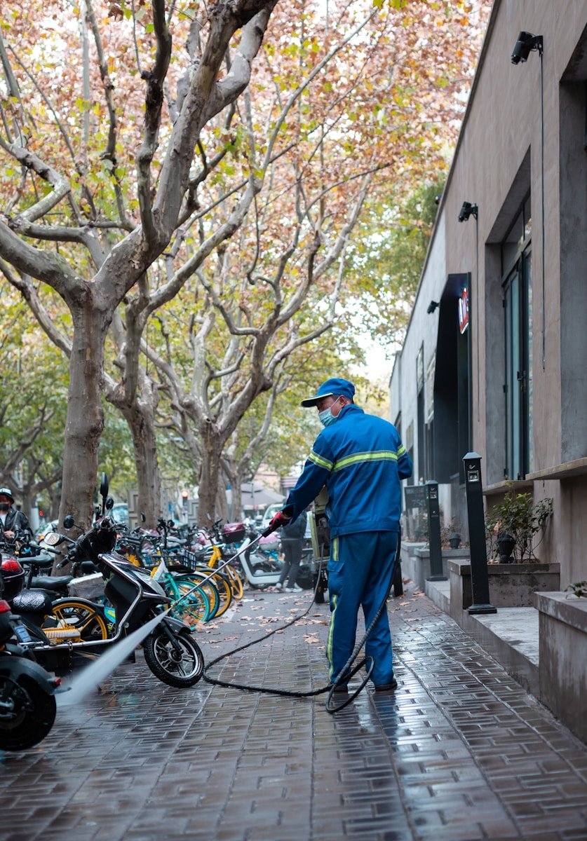 Limpieza Abella Orteguerira Coruña man in blue jacket and blue denim jeans standing beside black motorcycle during daytime